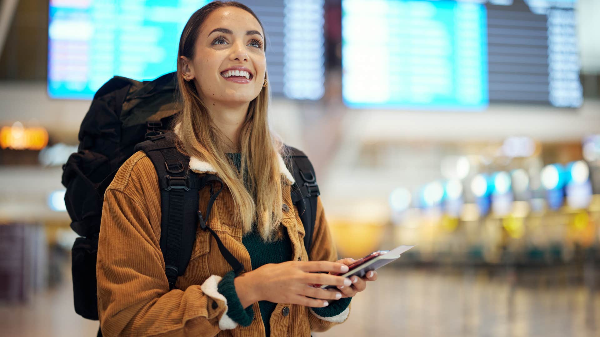 woman who's a procrastinator smiling in the airport