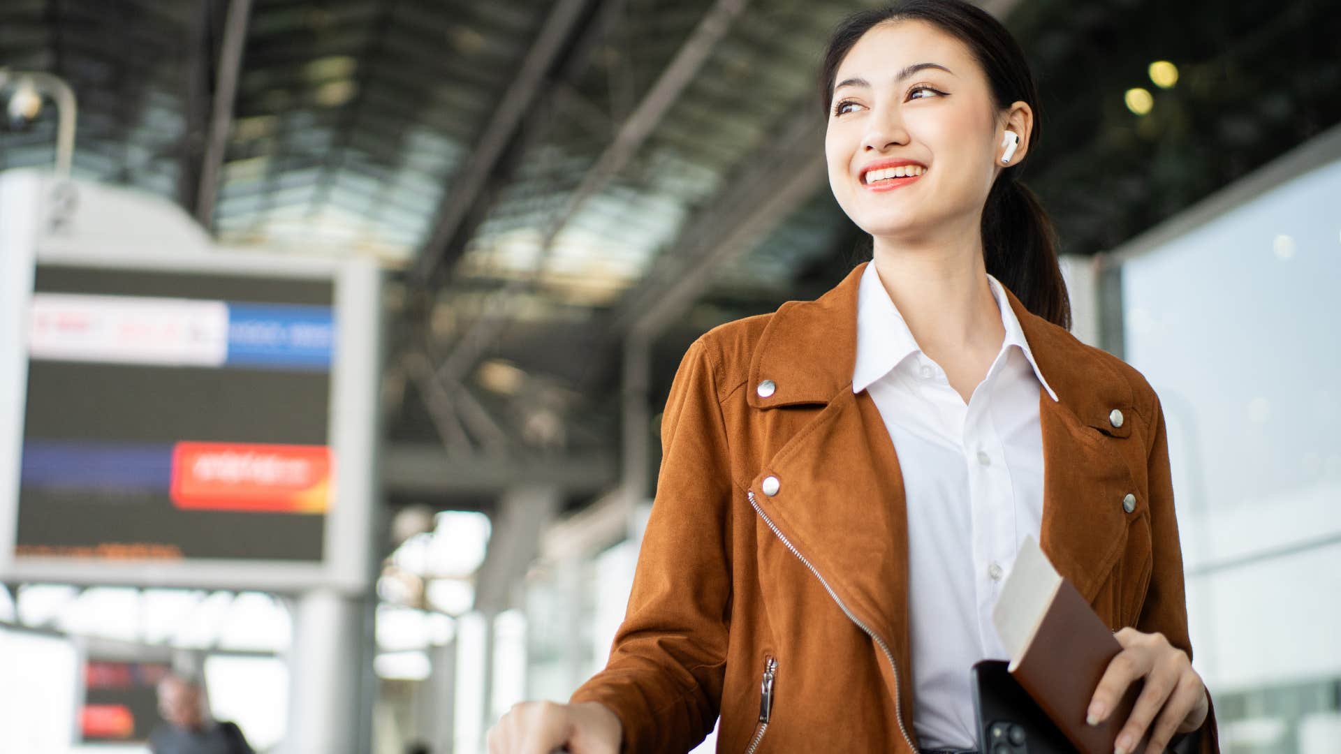 woman who works best under pressure smiling in the airport