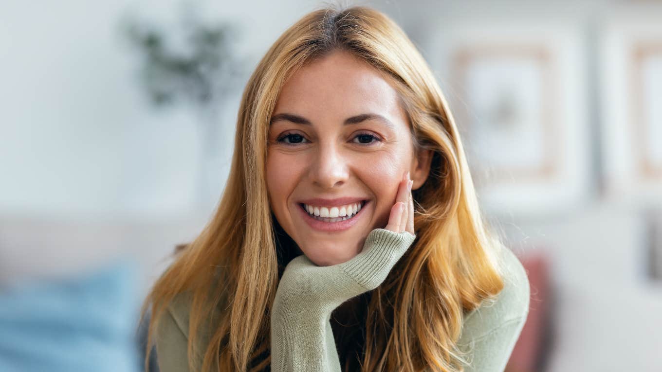 resilient woman smiling after surviving rock bottom