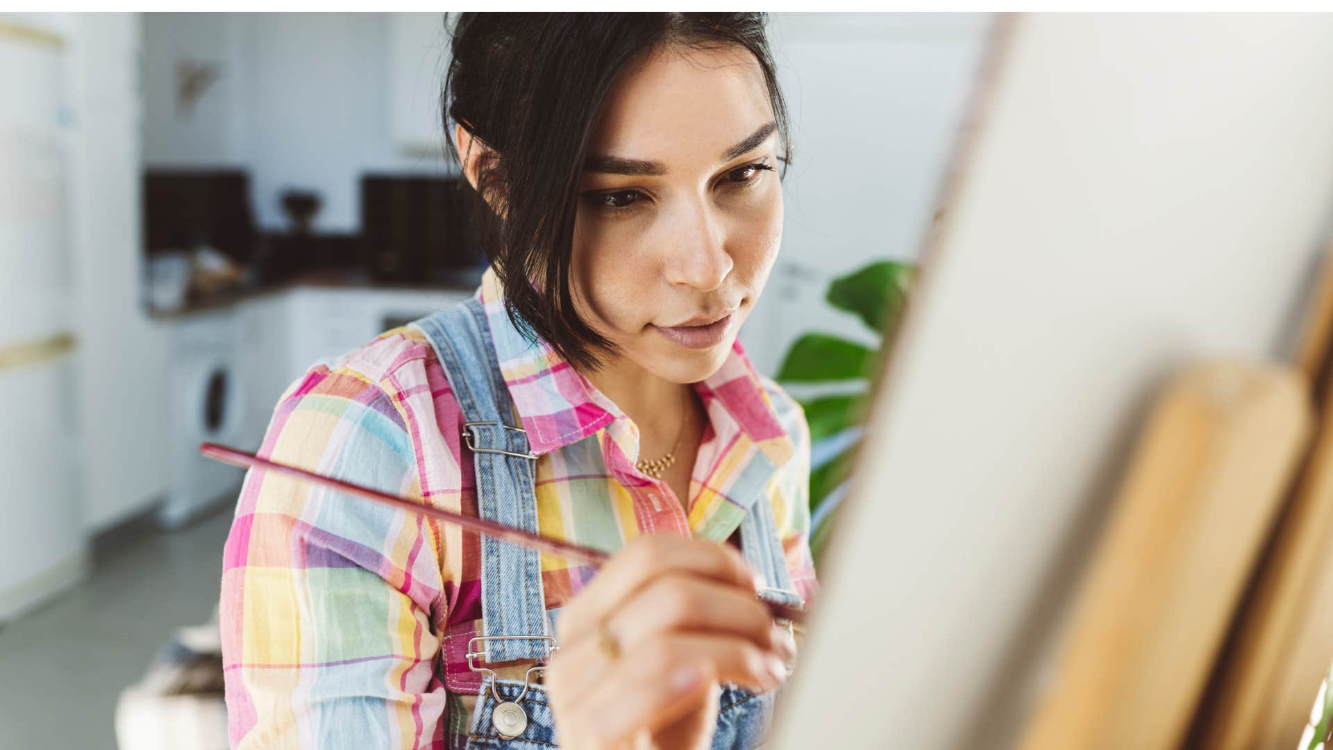 creative woman painting on a canvas