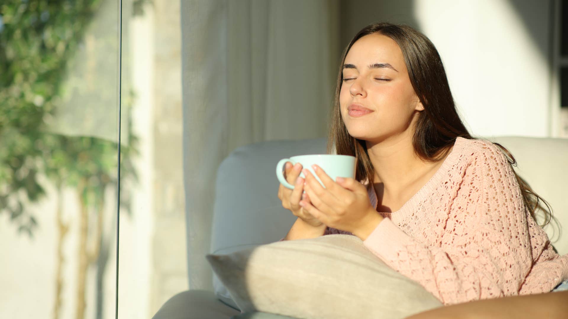 relaxed woman sitting at home in the sun