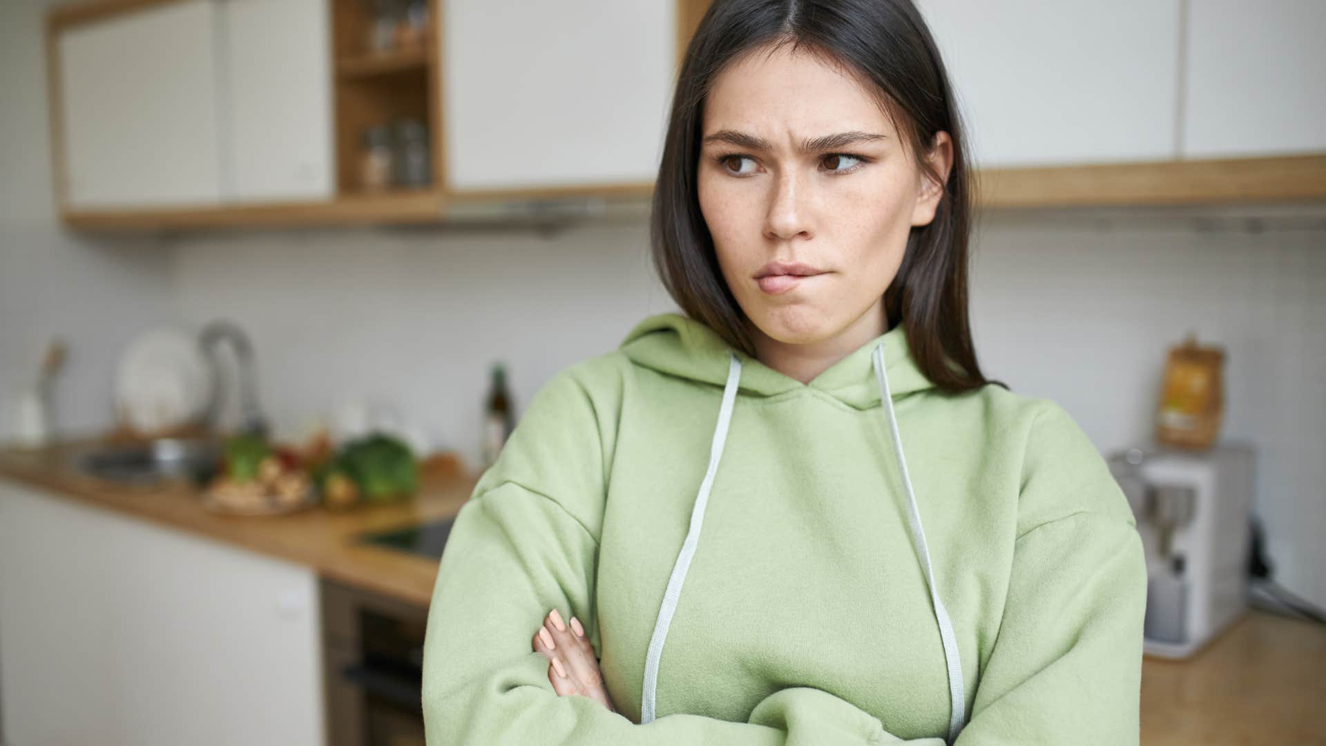 stubborn woman standing with her arms crossed