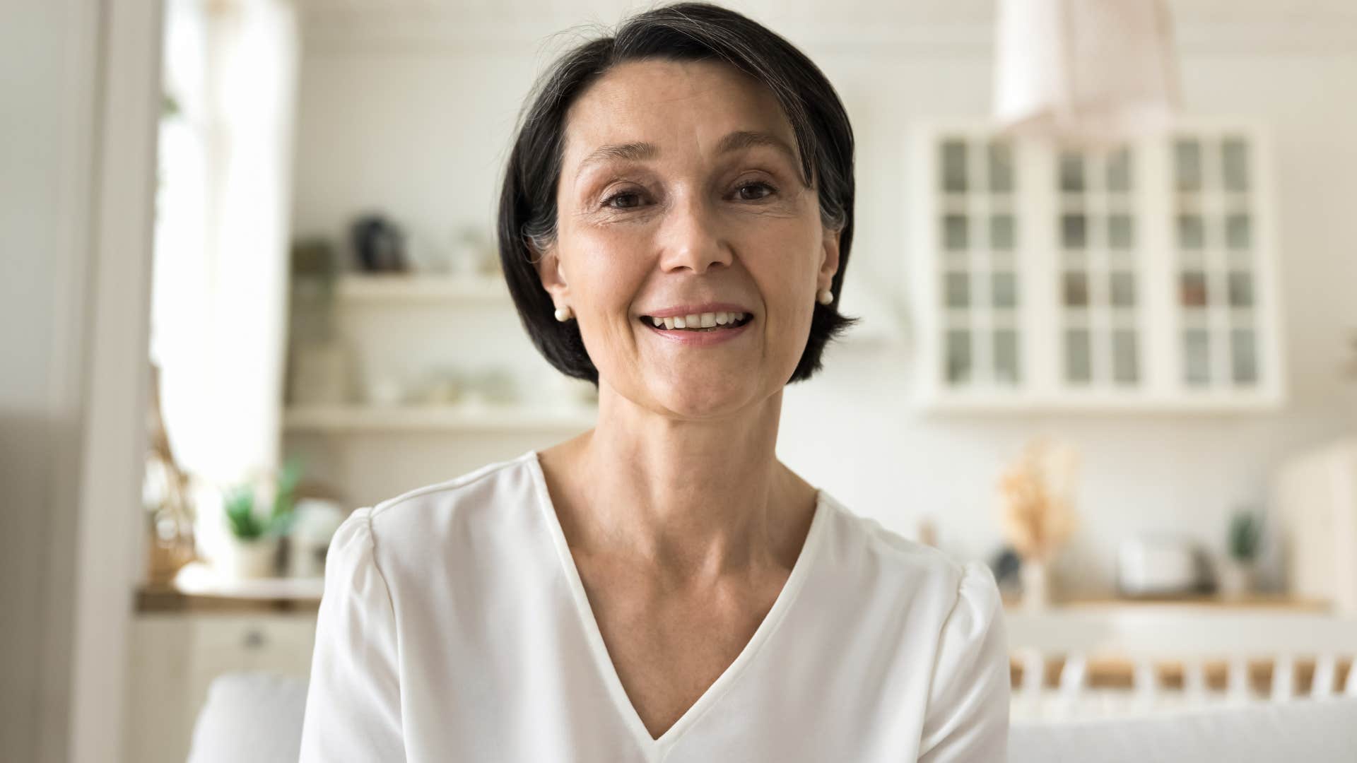 Woman saying "that's an interesting outfit" to people behind the camera.