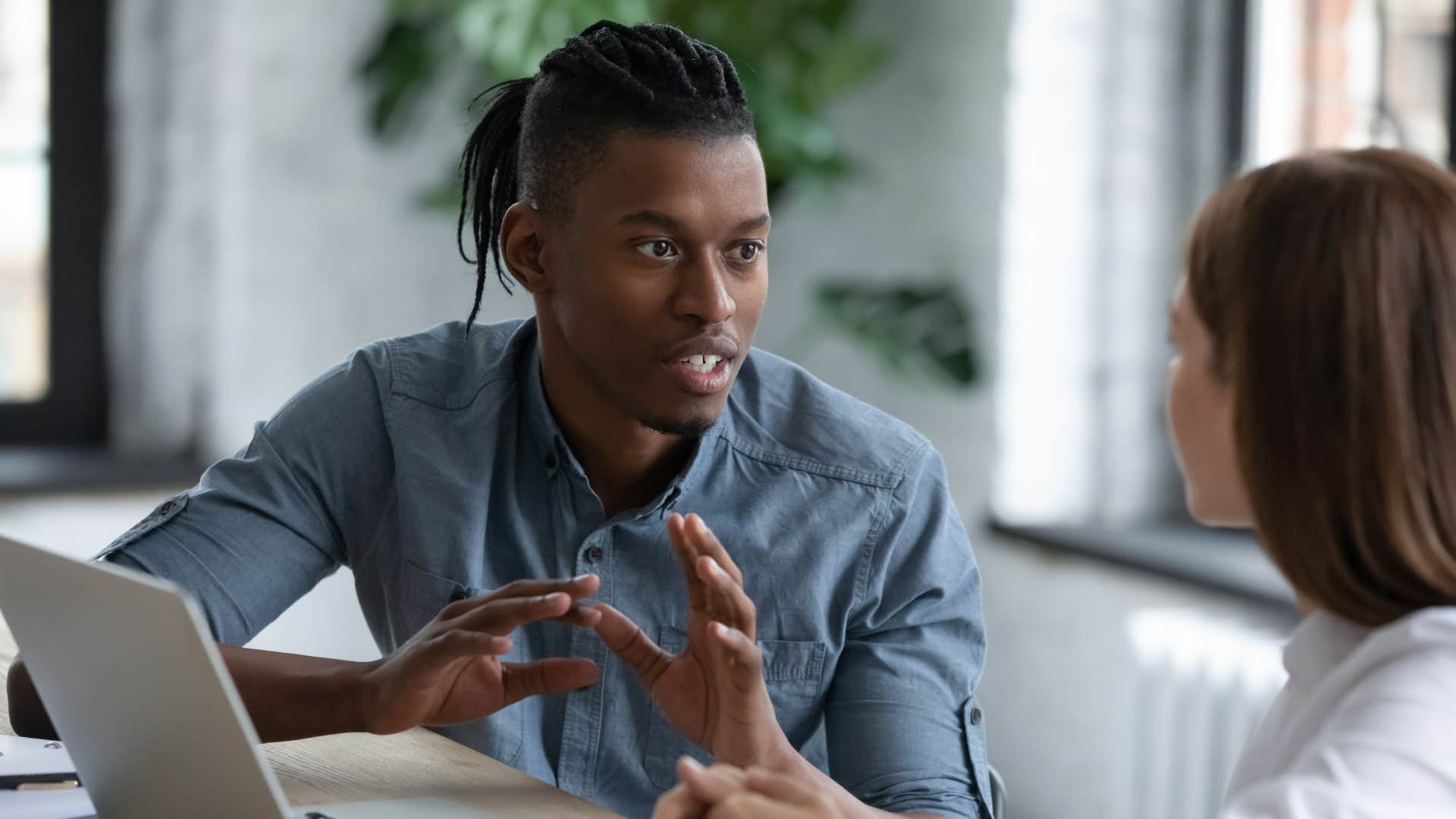 phrases brilliant people use instead of i knew that already that's been on my mind too man in blue shirt telling coworker that's been on my mind too as they sit down