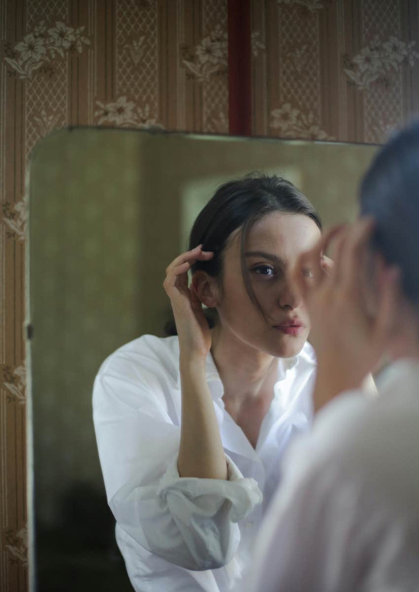 woman looking in the mirror