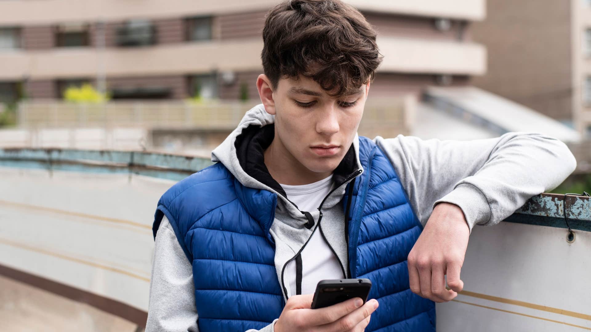 gen z man looking at social media on his phone