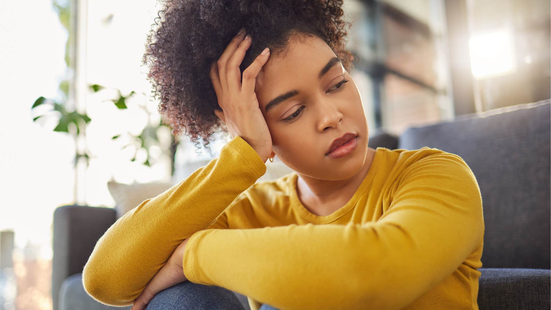 gen z woman who values and prioritizes rest sitting at home