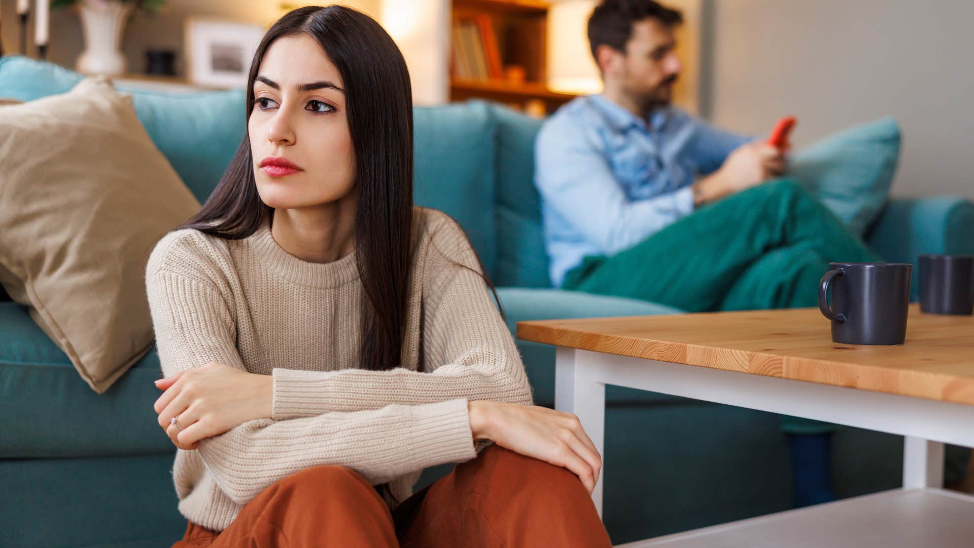 woman who's hiding something turned away from her husband