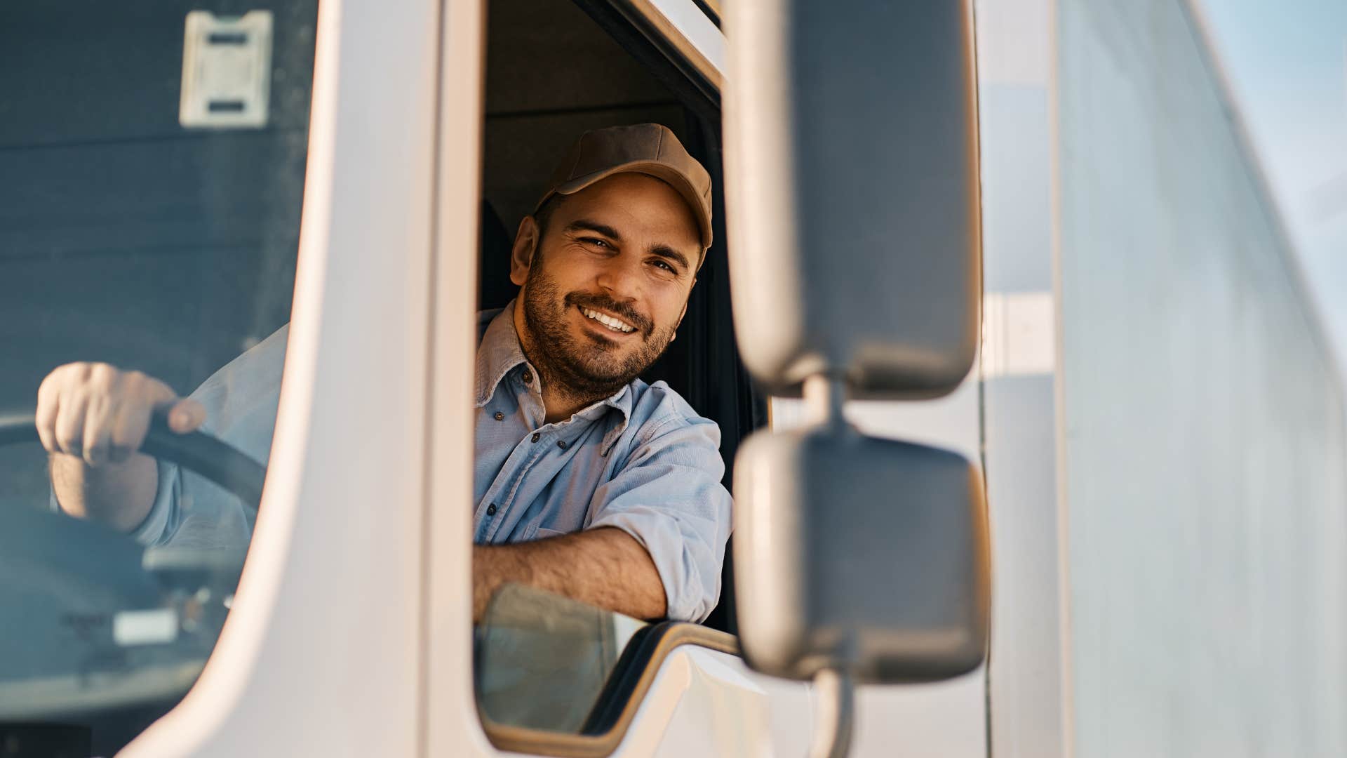 trucker in his vehicle smiling