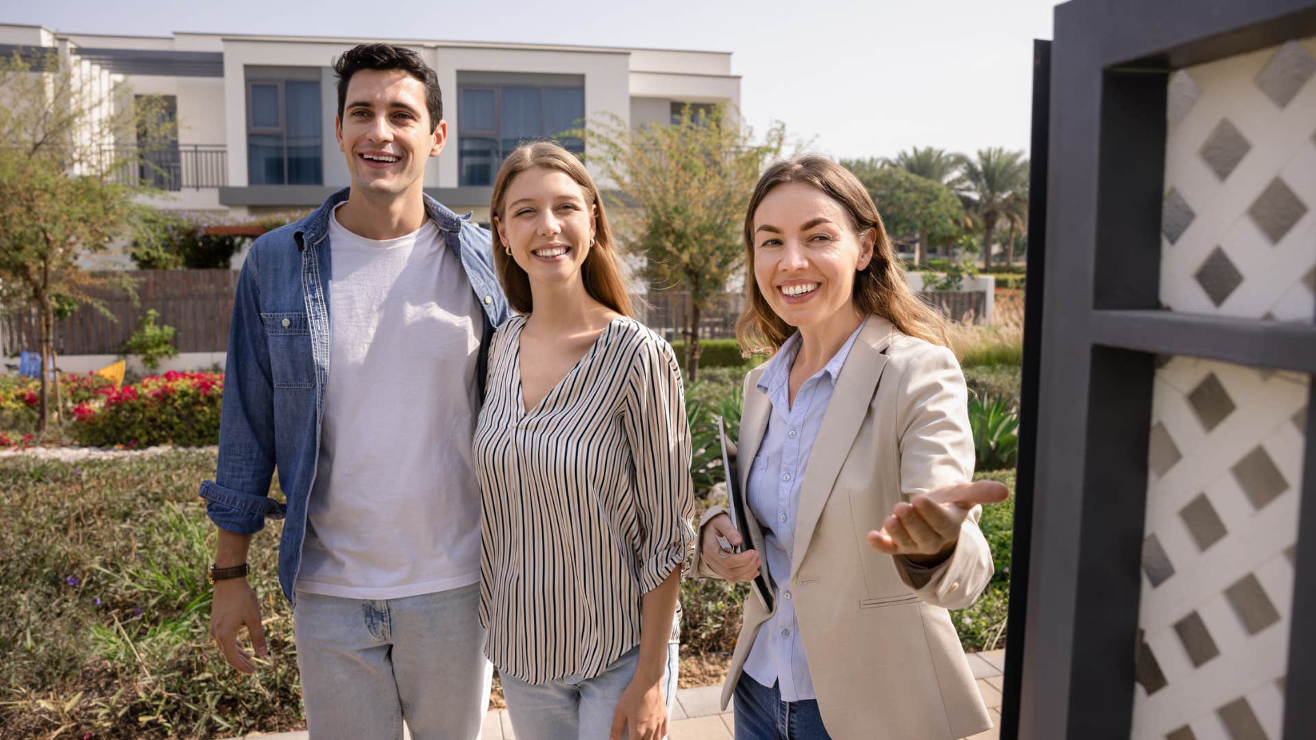 real estate agent showing clients a home