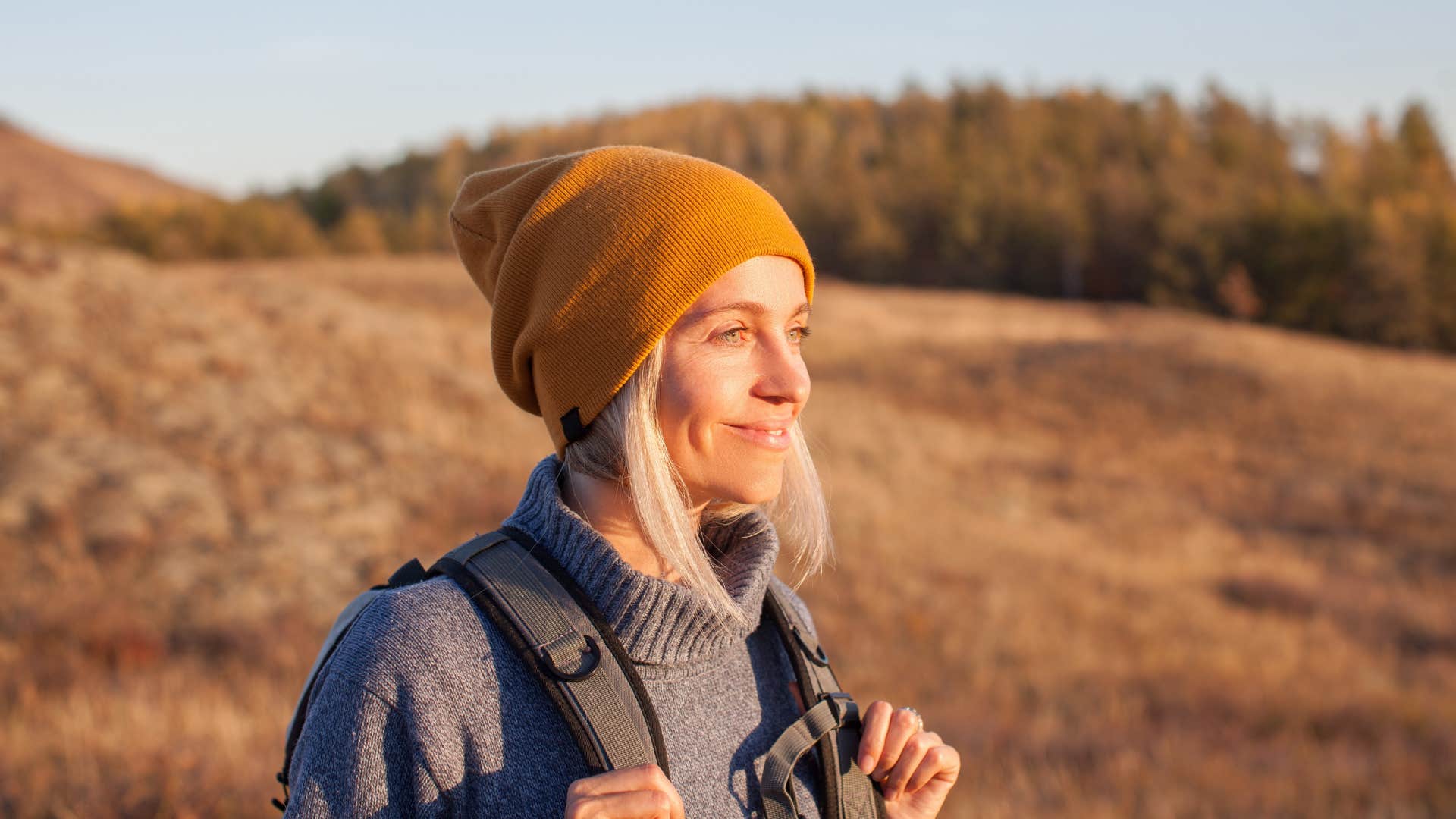 woman in gray sweater in nature as it resets her 