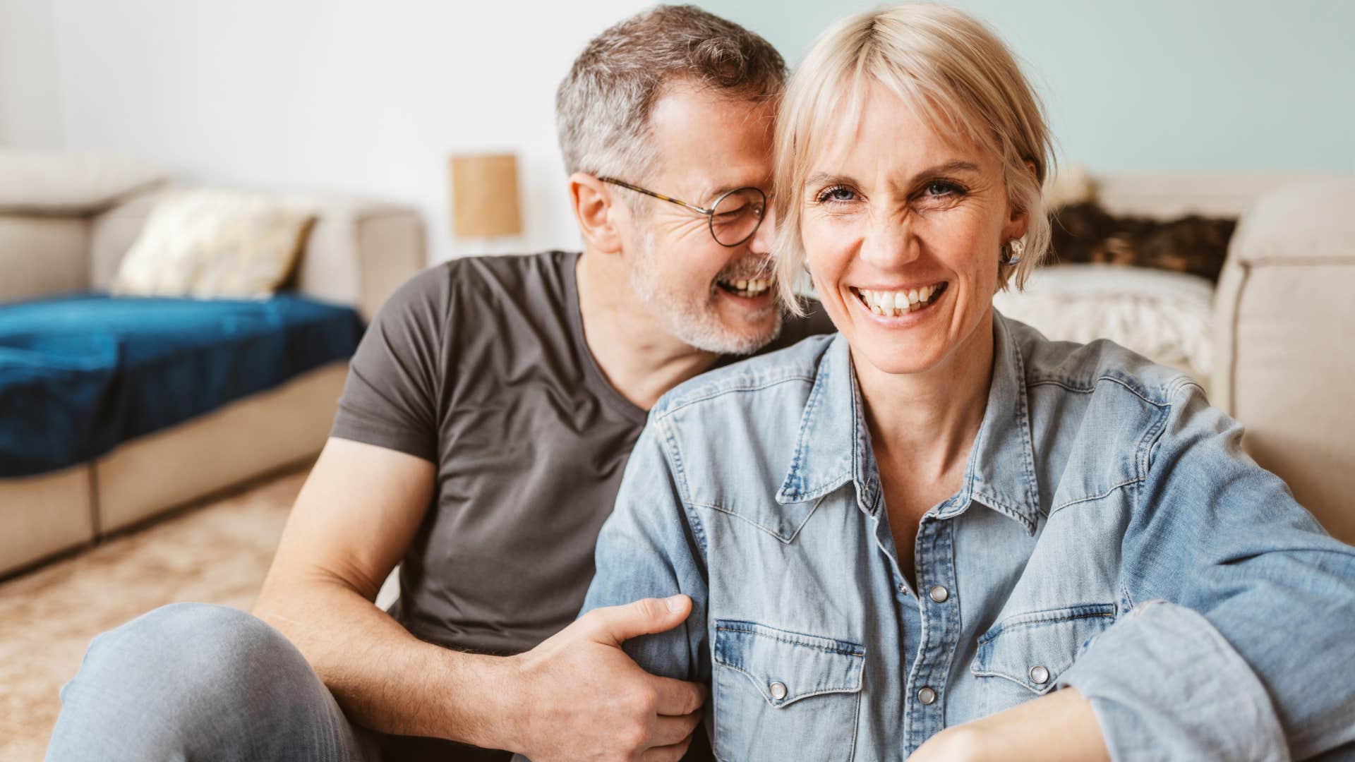 Couple who's both confident hugging at home.