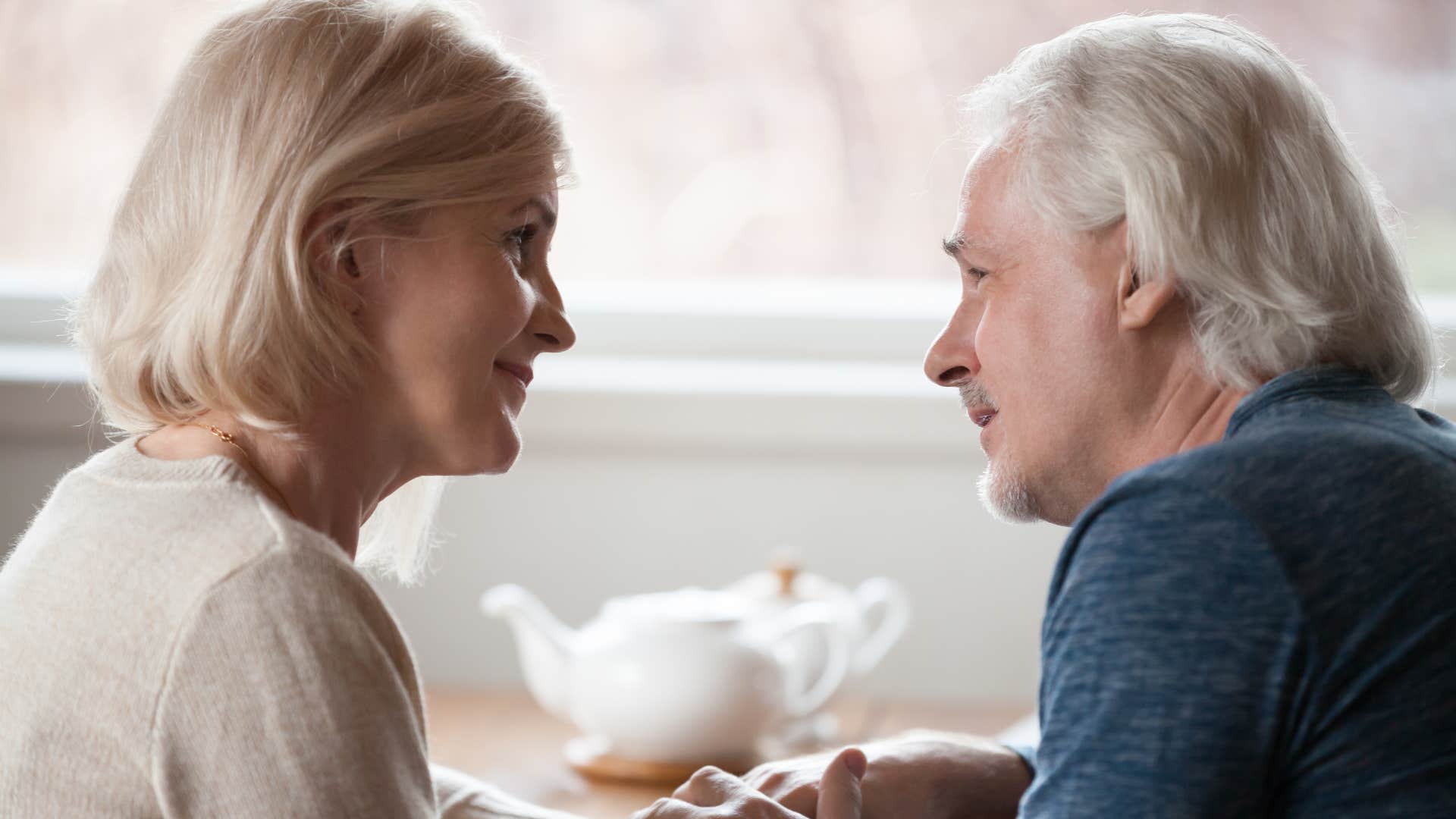 Couple who resolves conflict on the same team looking at each other.