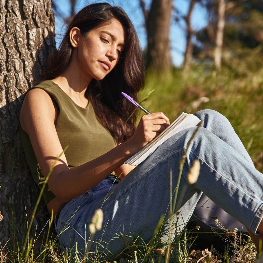 woman who is naturally sincere as she writes things down