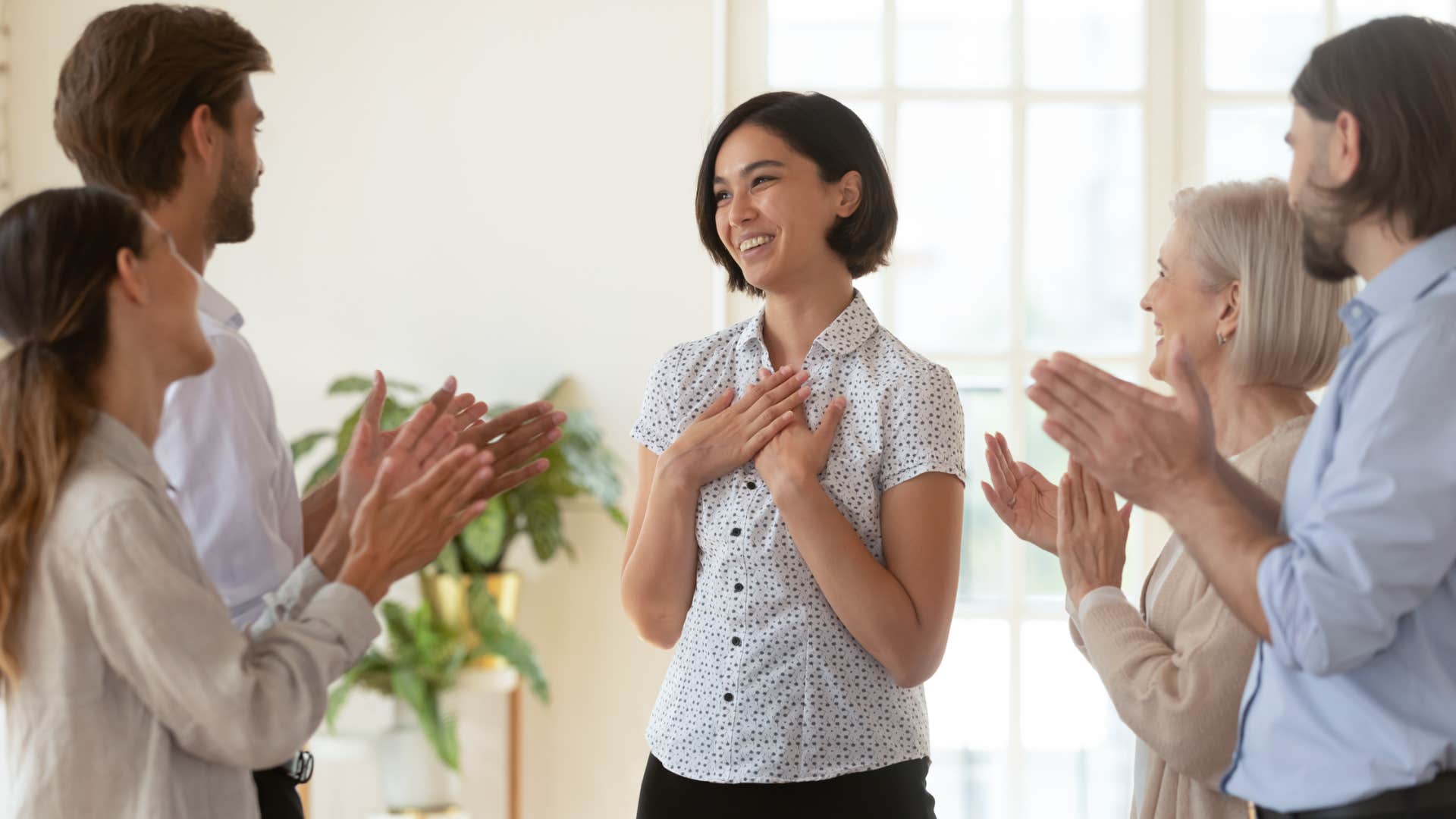 co-workers congratulating colleague on success