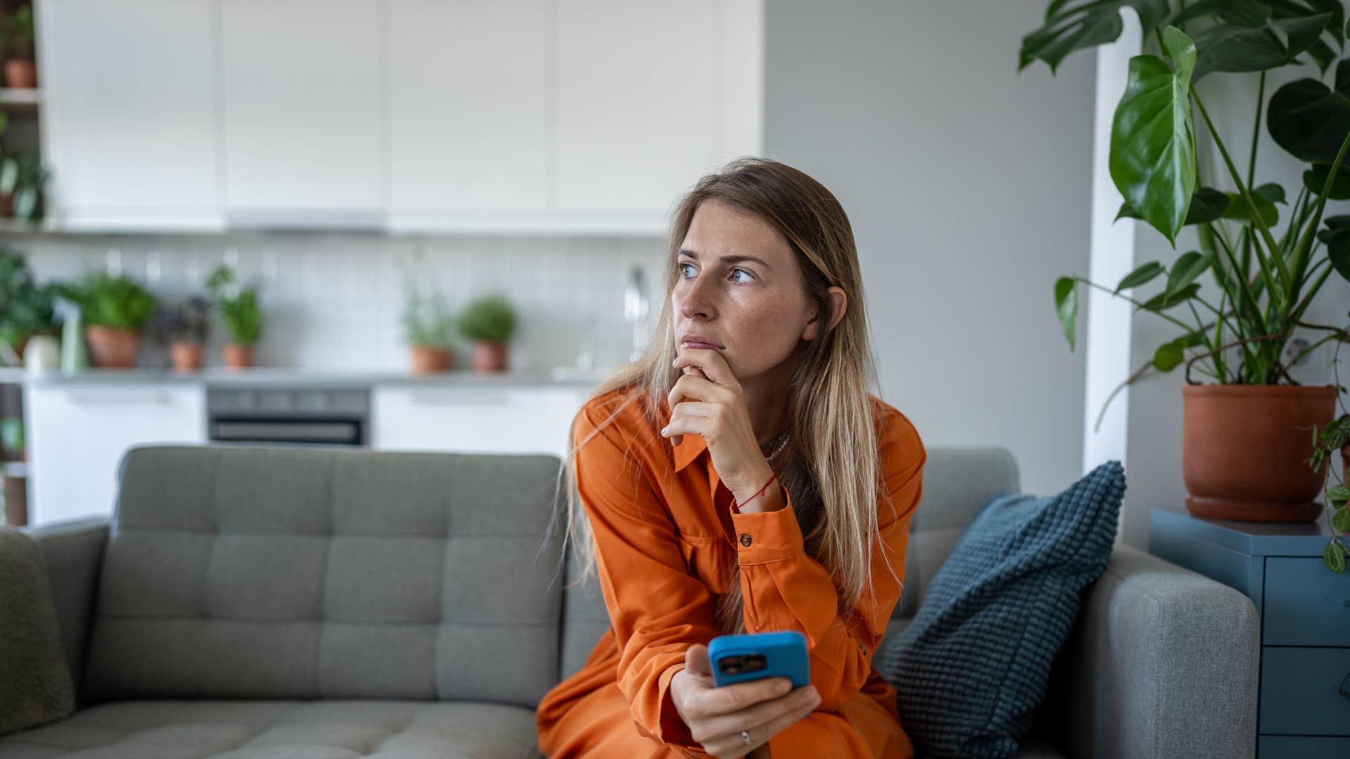 woman sitting in living room with no decorations