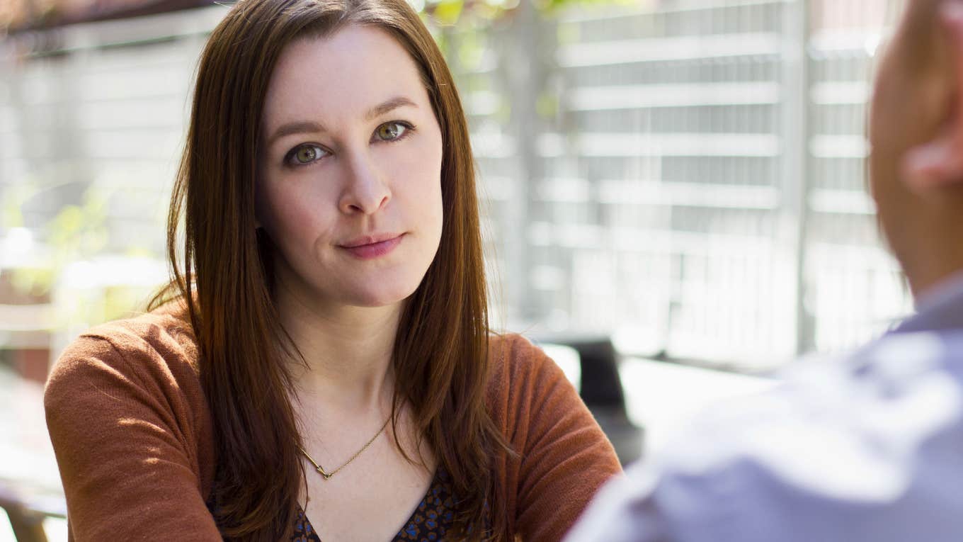If Someone Who Doesn't Like You Is Too Polite To Admit It, They'll Start Saying These Things Casually woman unimpressed with man looking annoyed