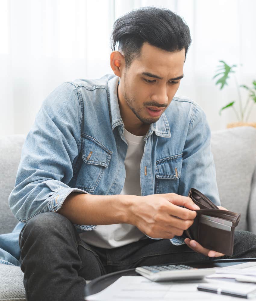 man with empty wallet who spent his whole paycheck