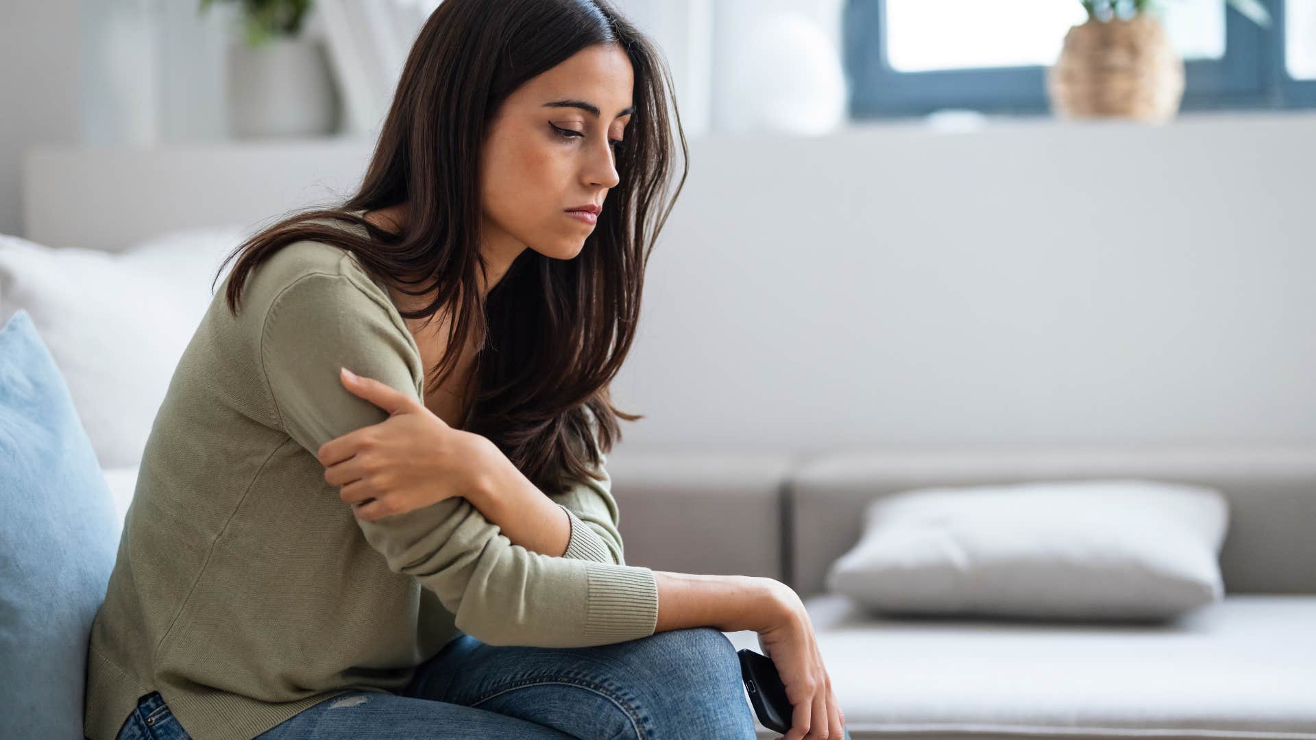 woman who is getting chronic headaches because she can't let go of the past