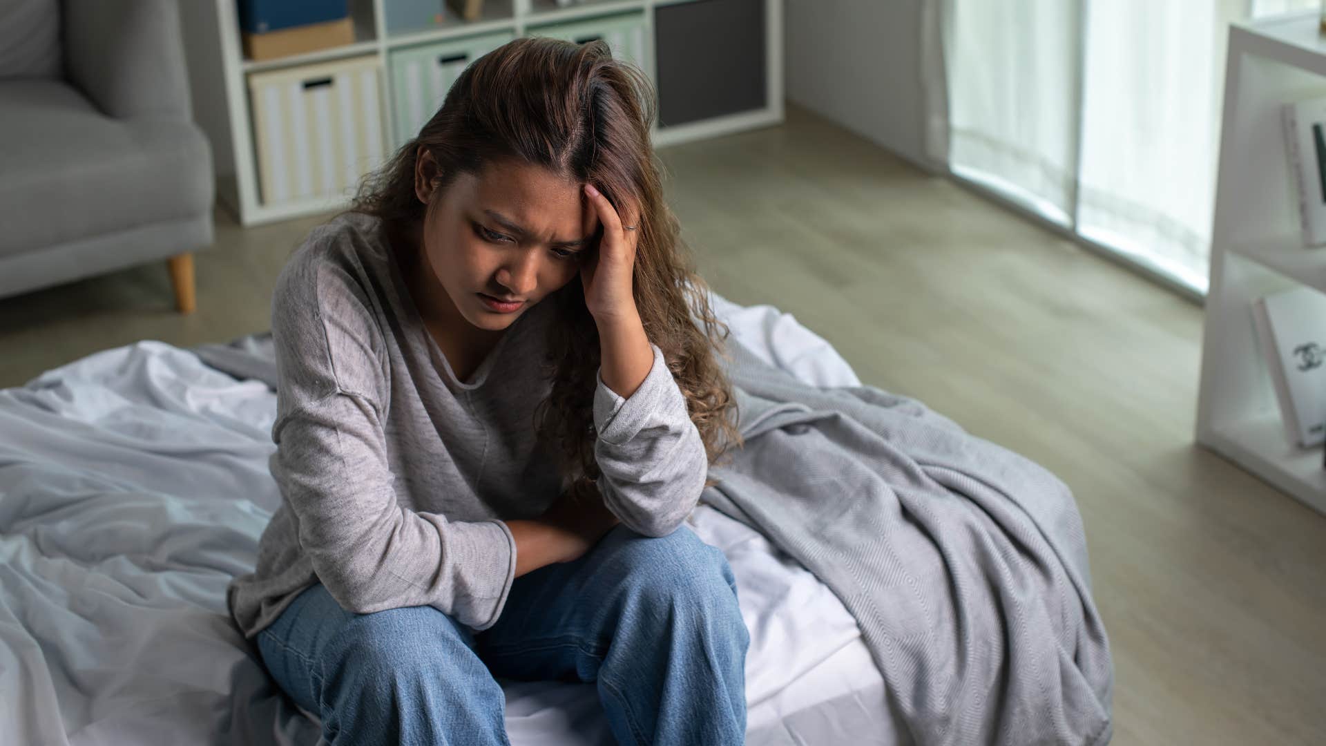 woman who has chronic headaches because of negative energy