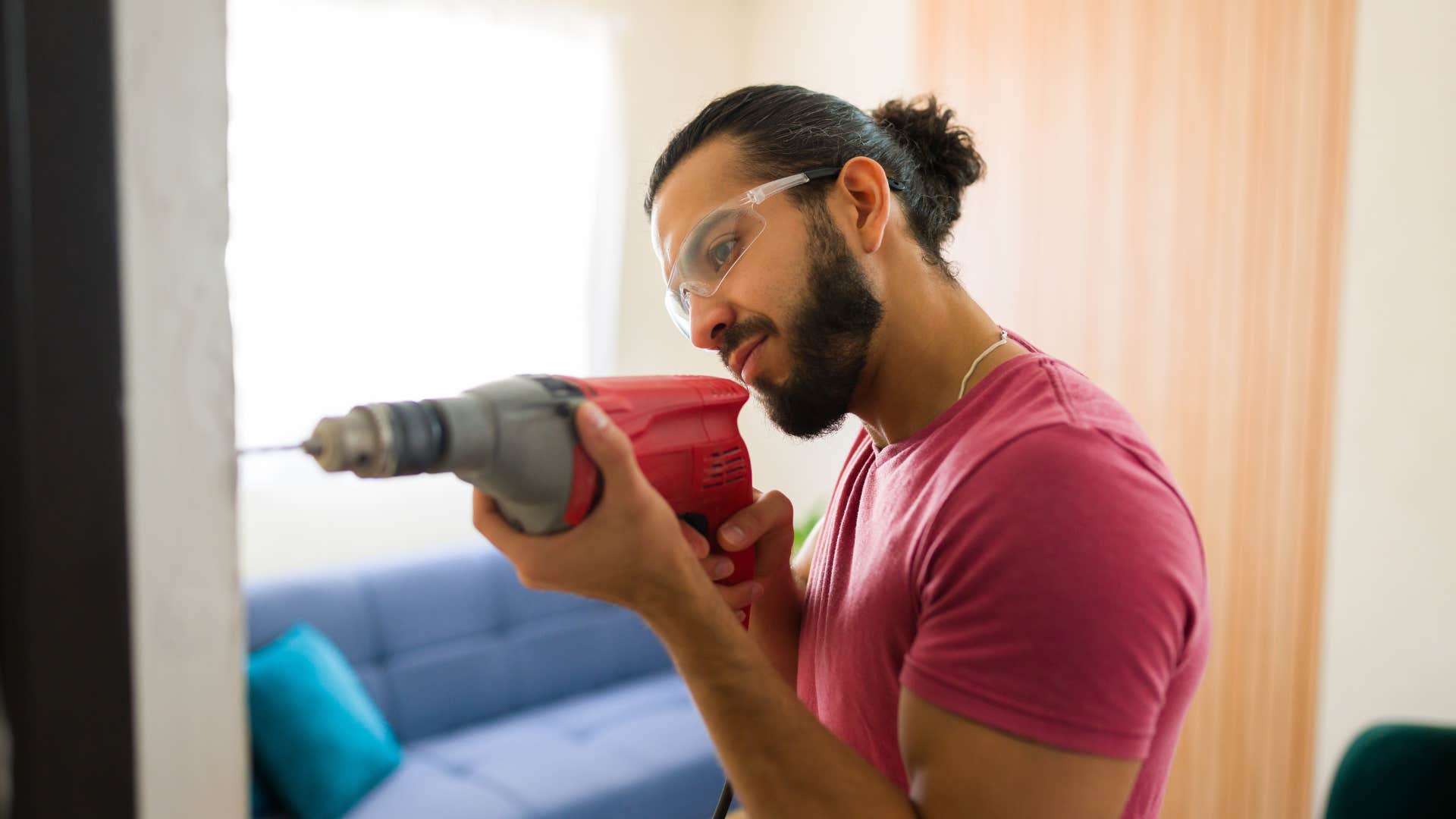 man fixing wall at home