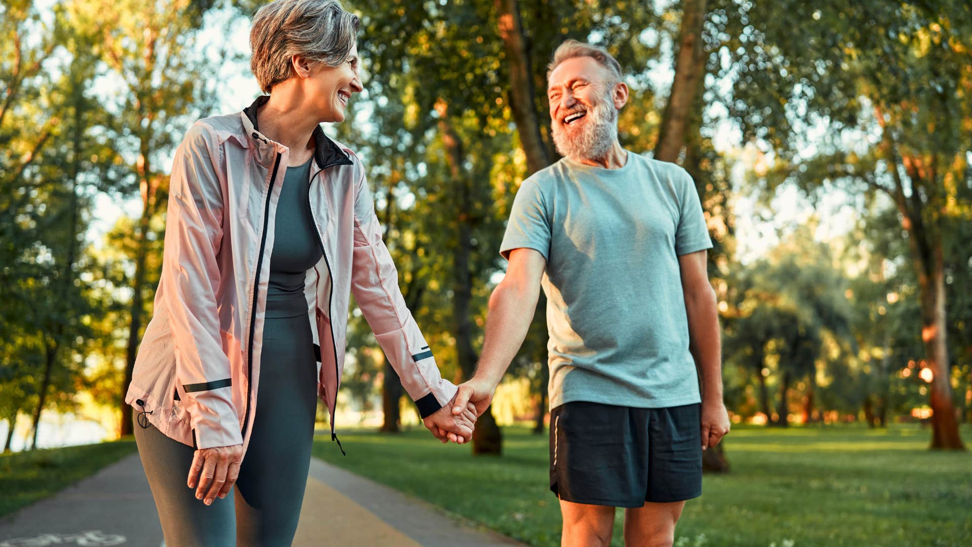 husband holding wife's hand while on walk