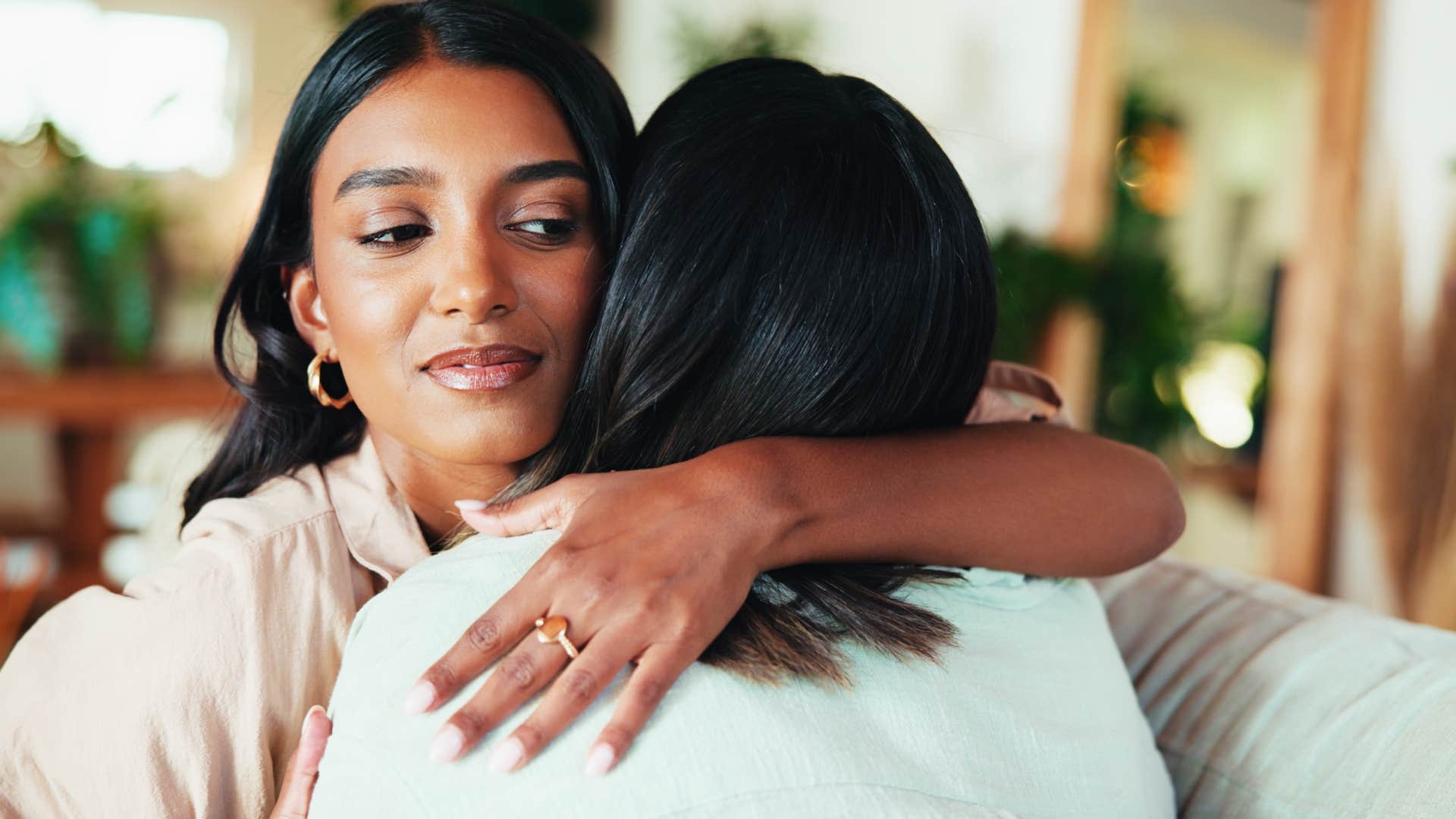 woman with bad intentions hugging friend