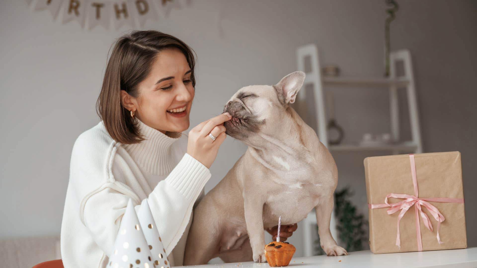 woman giving dog treat