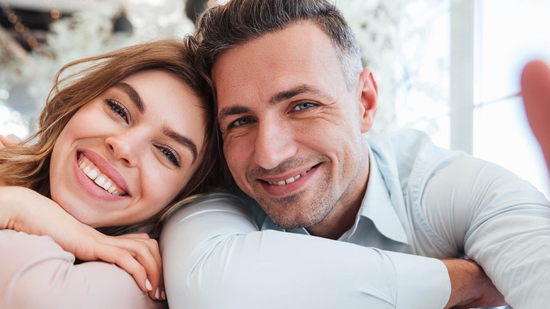 man who feeds into a safe space smiling with his wife