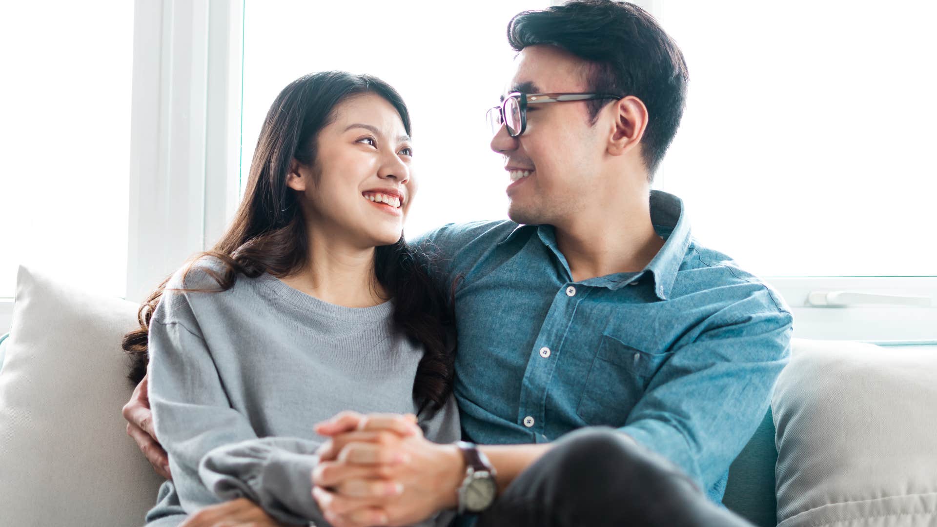 patient man smiling with his wife at home