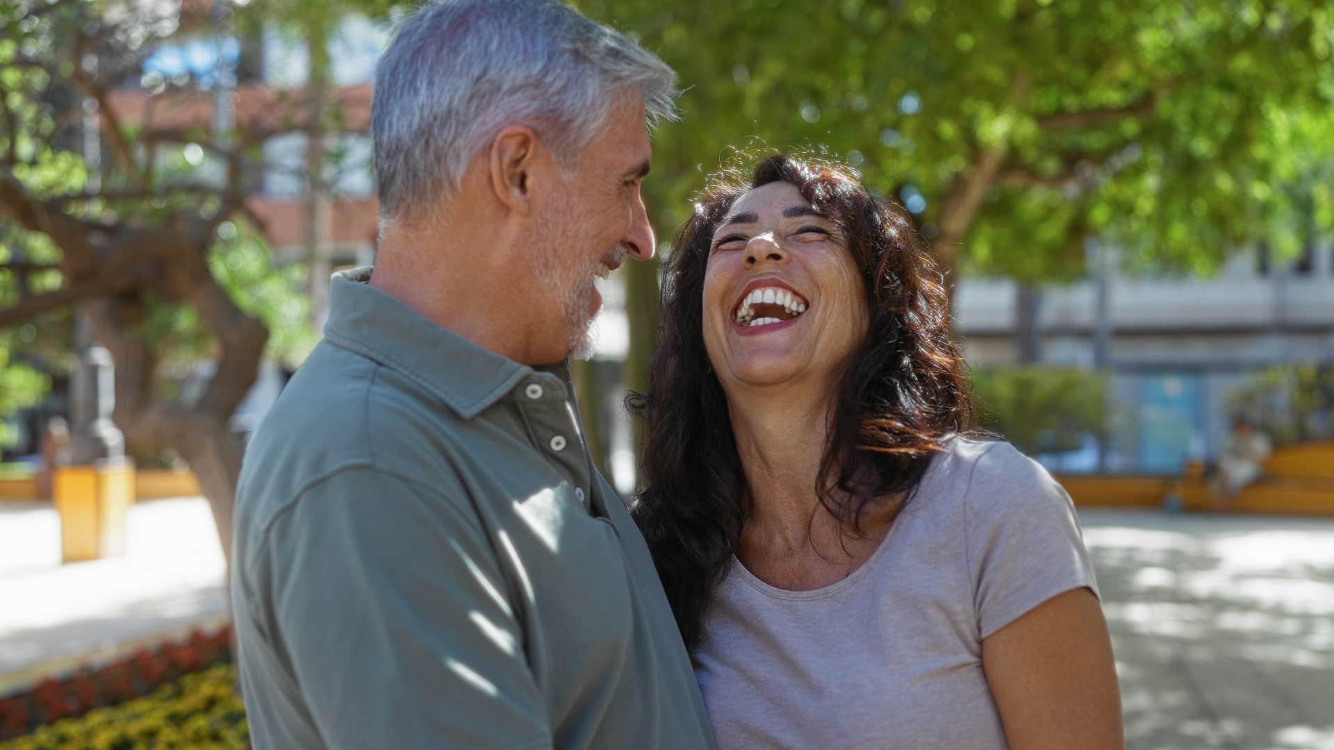 man who regularly asks for partner's advice laughing with her