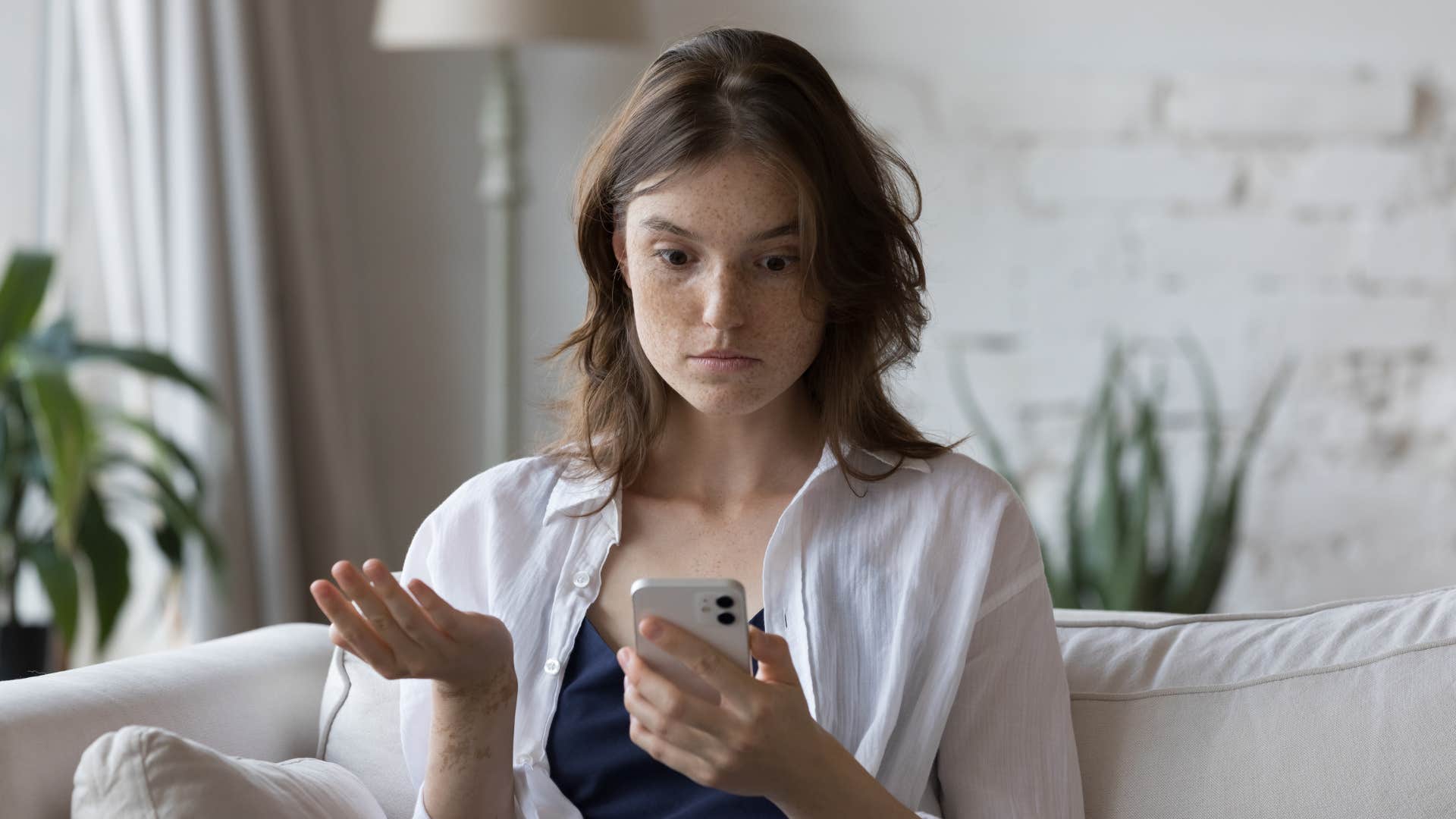 things adults with actual morals are tired of at this stage of their lives double standards woman in white shirt dealing with double standards as she looks at phone annoyed