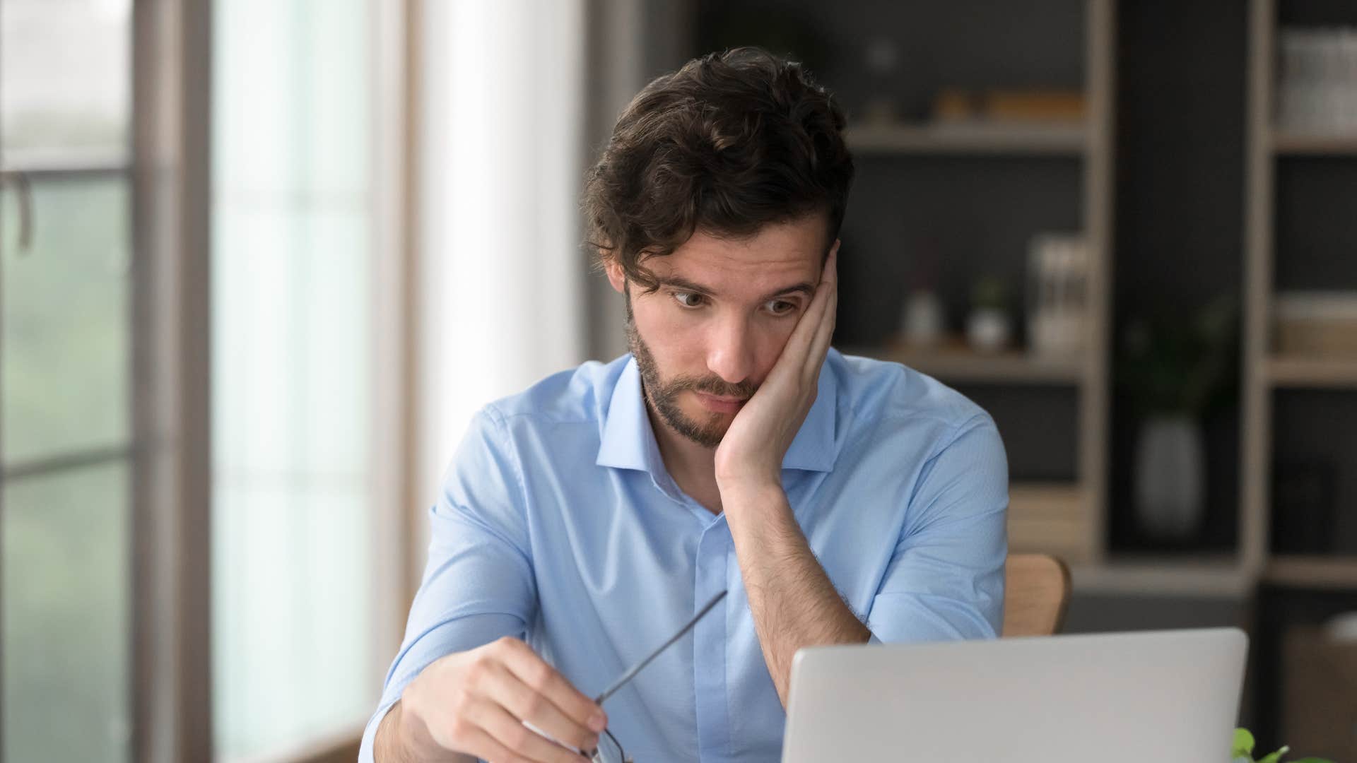 things adults with actual morals are tired of at this stage of their lives toxic workplace that prioritizes profit over people man in blue shirt looking annoyed as workplace prioritizes profit over people