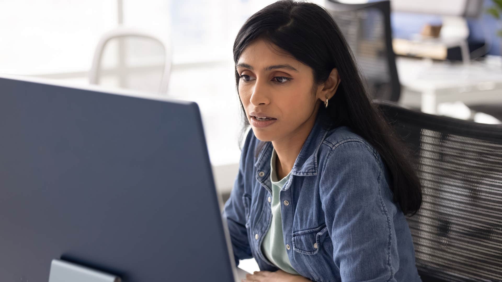 Woman who's being shamed for taking time off sitting at work.