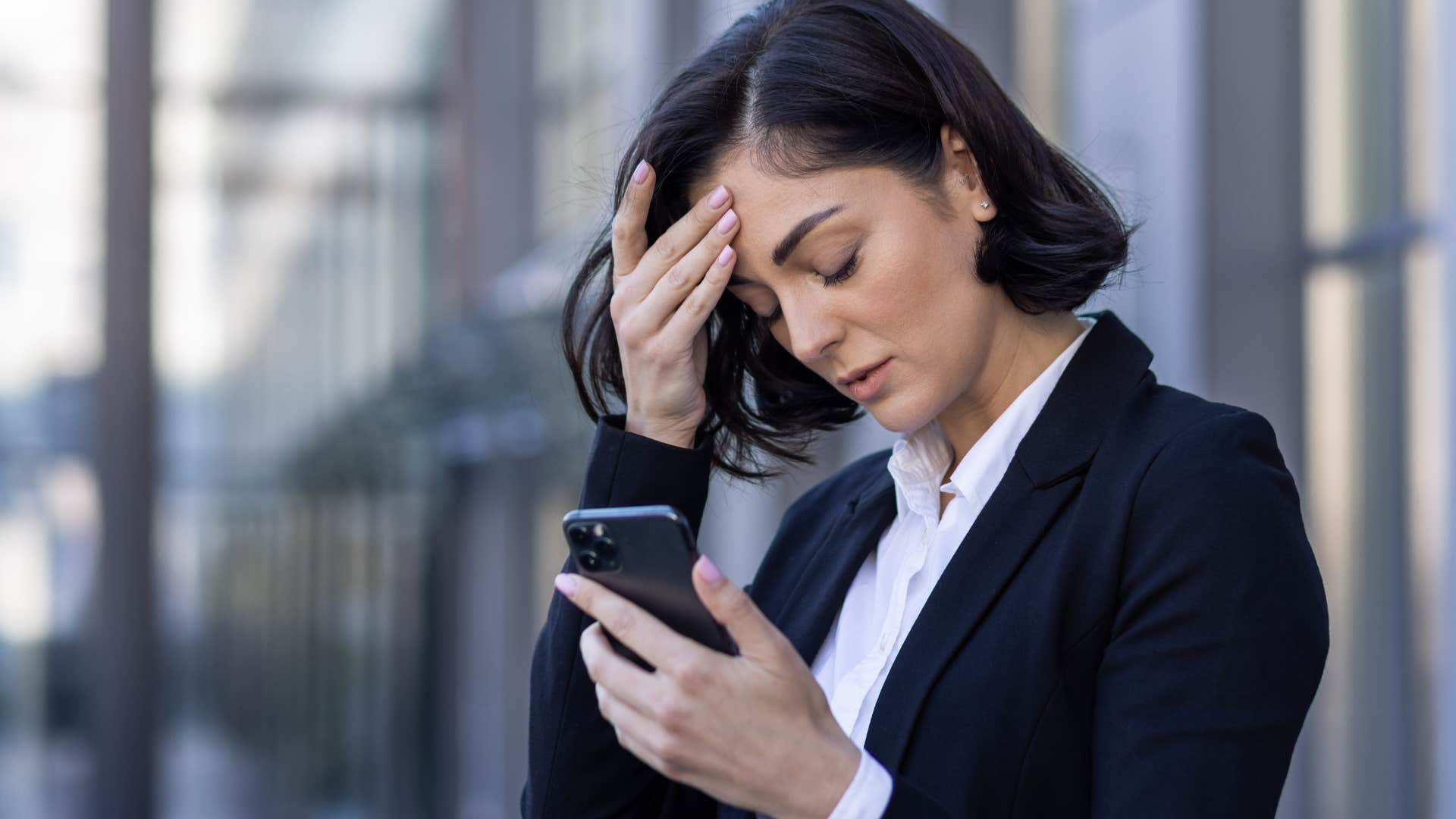 Woman comparing their lives to social media on their phone.