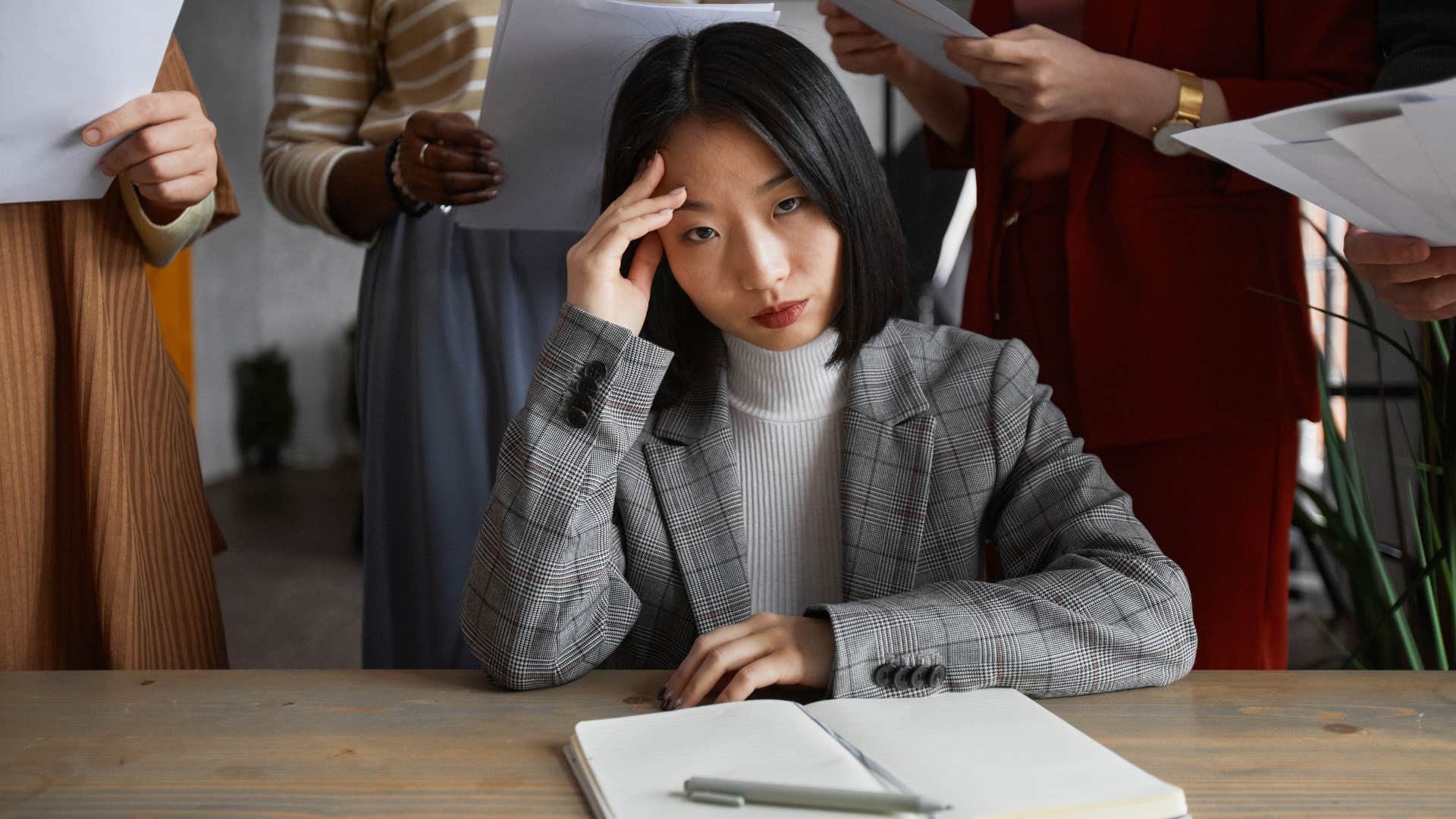 Woman wasting time with meetings that could've been emails at work.