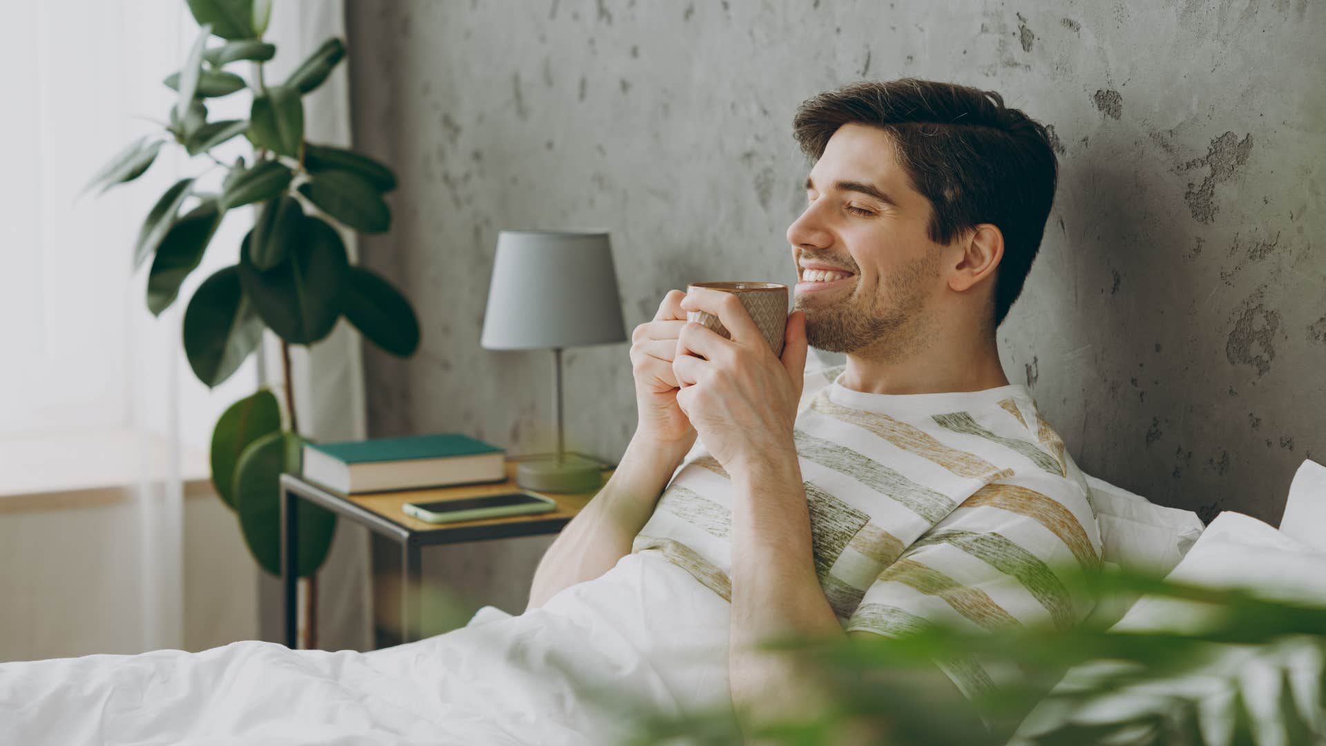 man relaxing and resting in bed