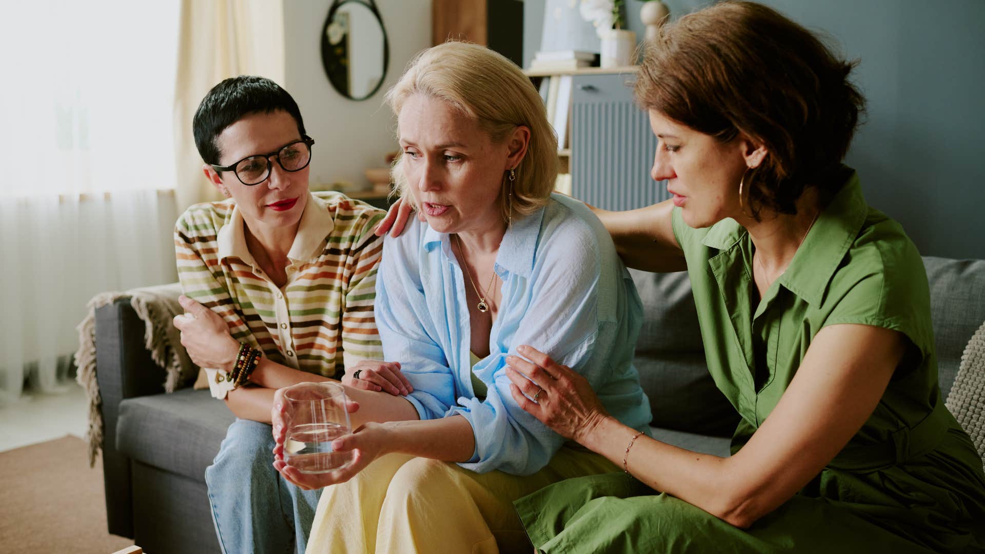 group of friends comforting woman