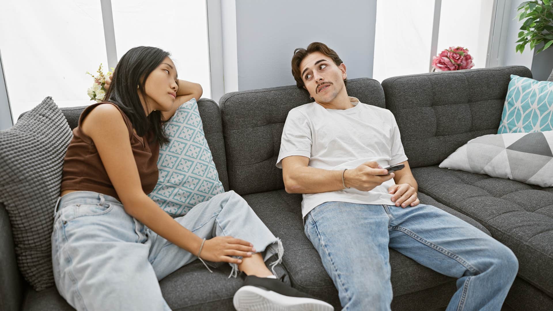 couple sitting in silence on the couch together