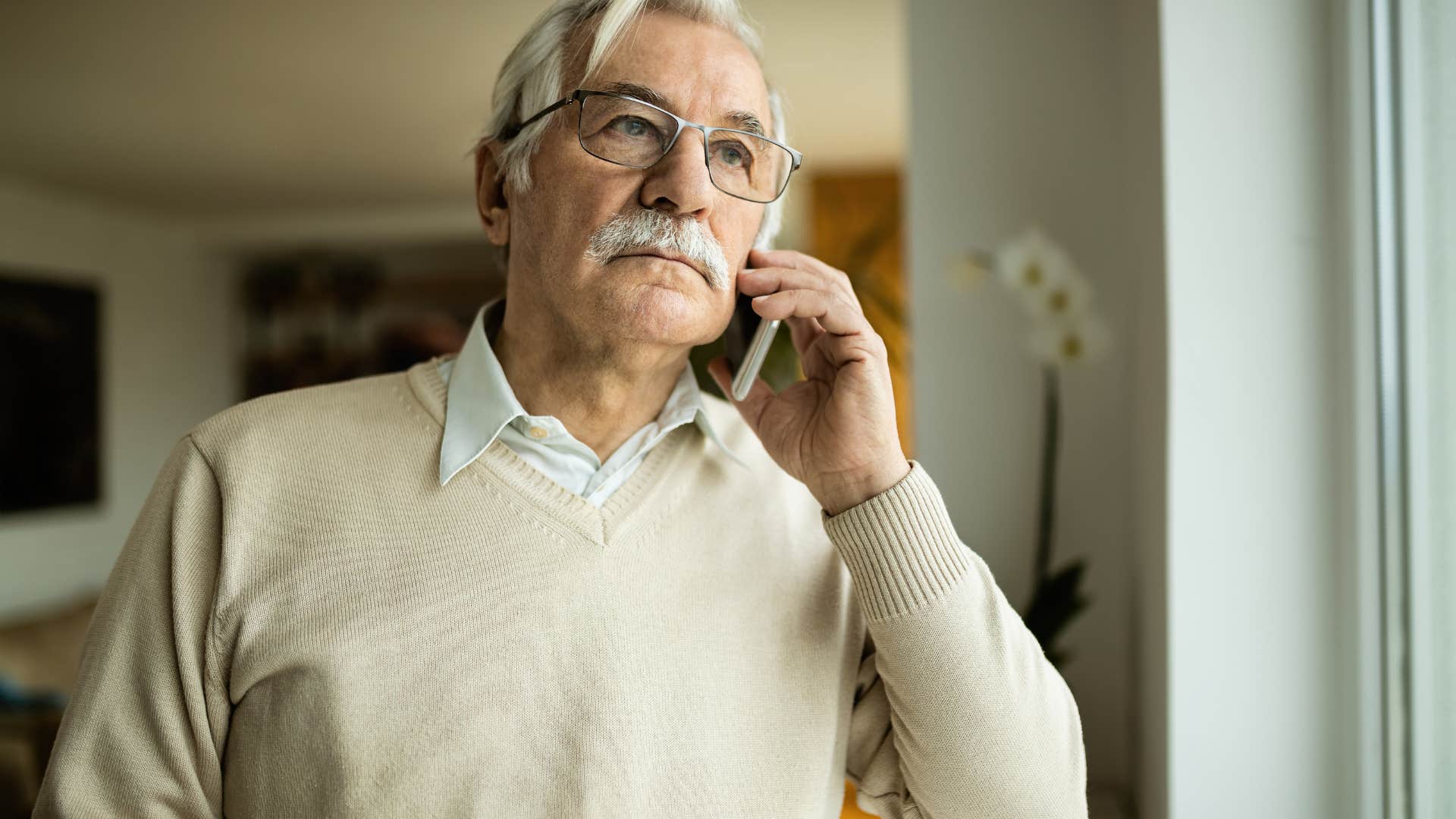 older man talking on phone