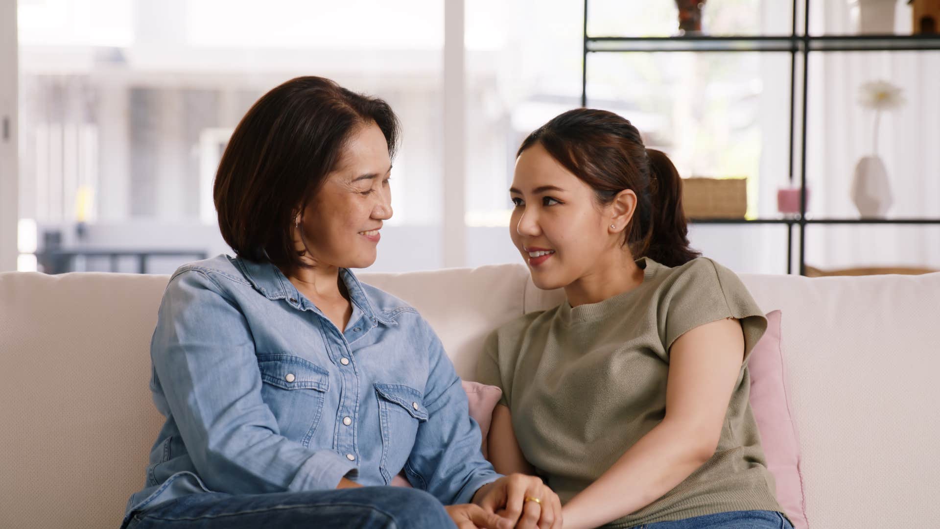 mom talking to daughter on couch