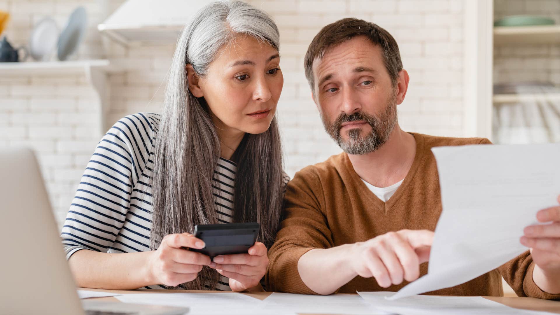 couple doing bills in their ignored money corner at home
