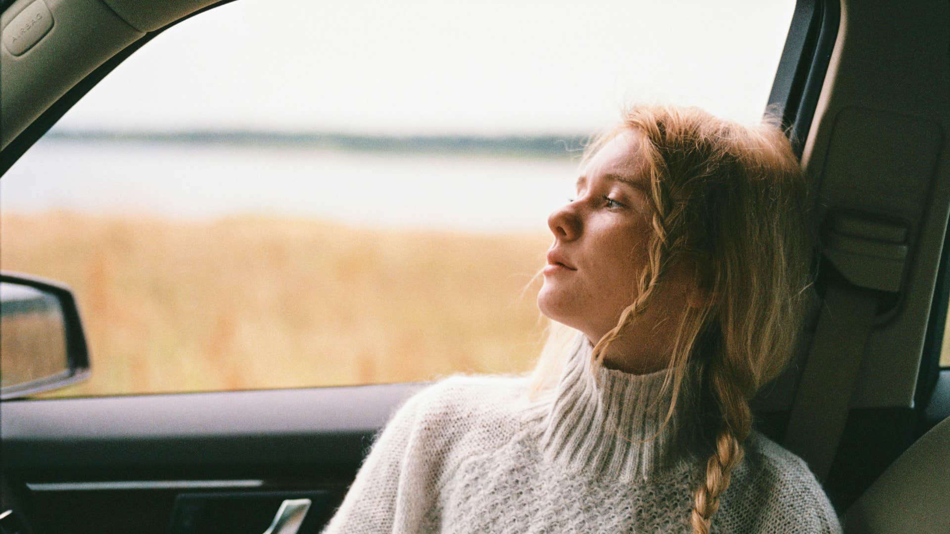 woman in sweater has no passion as she stares out the window
