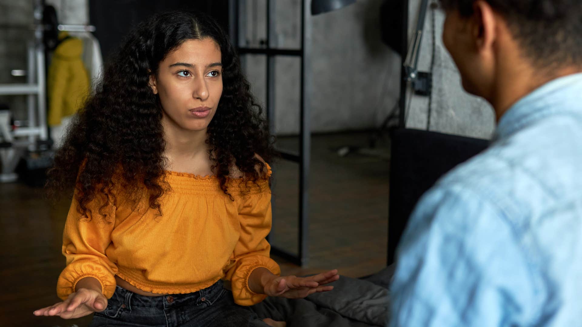 woman in orange shirt never sets boundaries as she talks to man