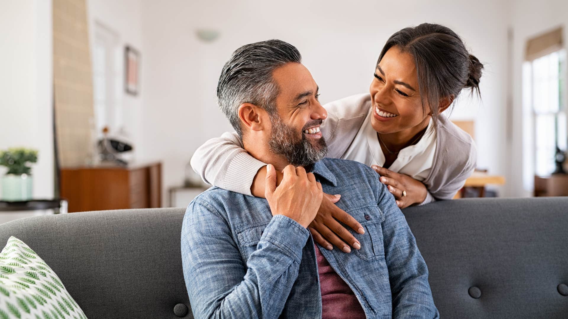 woman in white shirt puts him first all the time as she hugs him