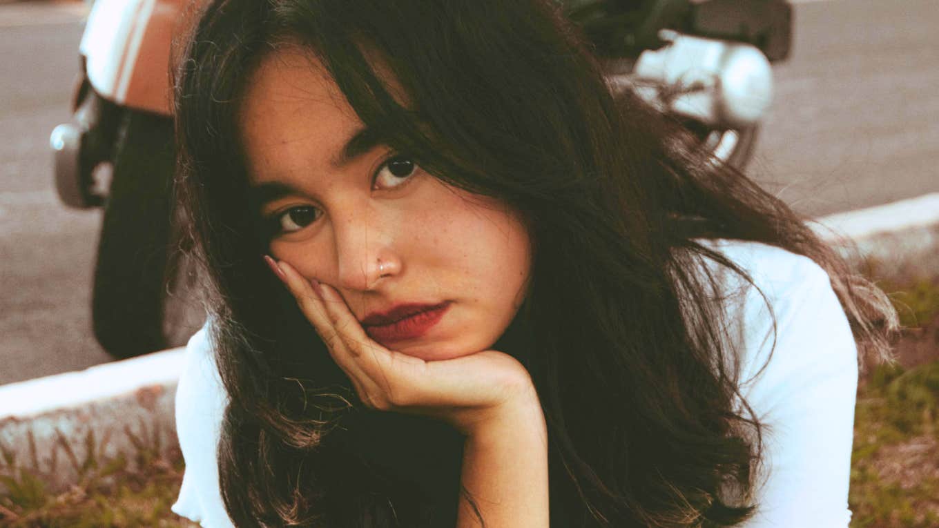 Things Hit Close Home Time Send Man Packing Sad woman resting her hand under her chin, illustrating signs it may be time to end a relationship with a problematic partner