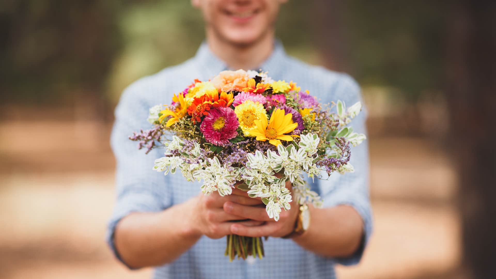 Man giving bouquet of flowers
