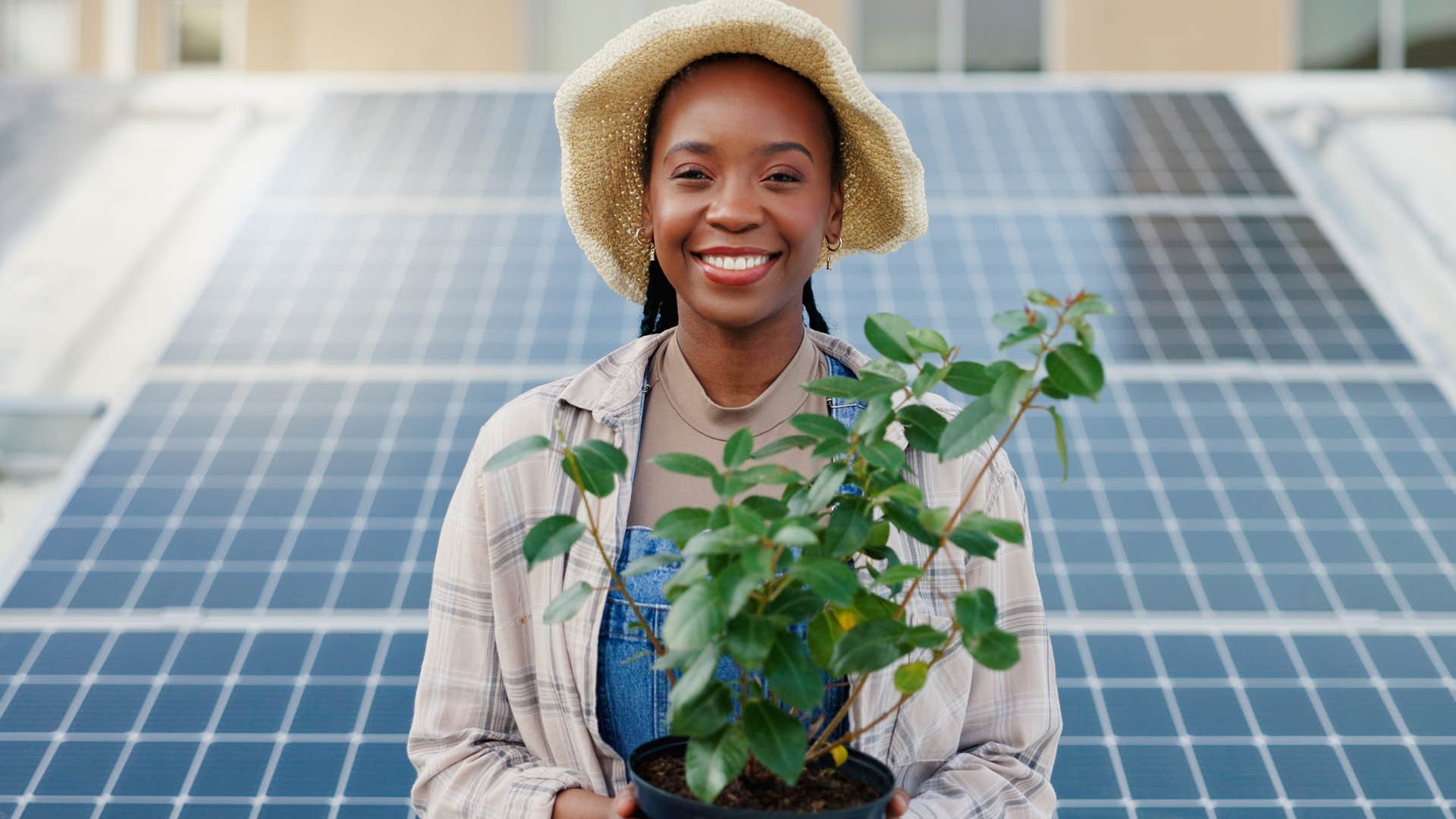 millennial woman championing sustainability holding a plant