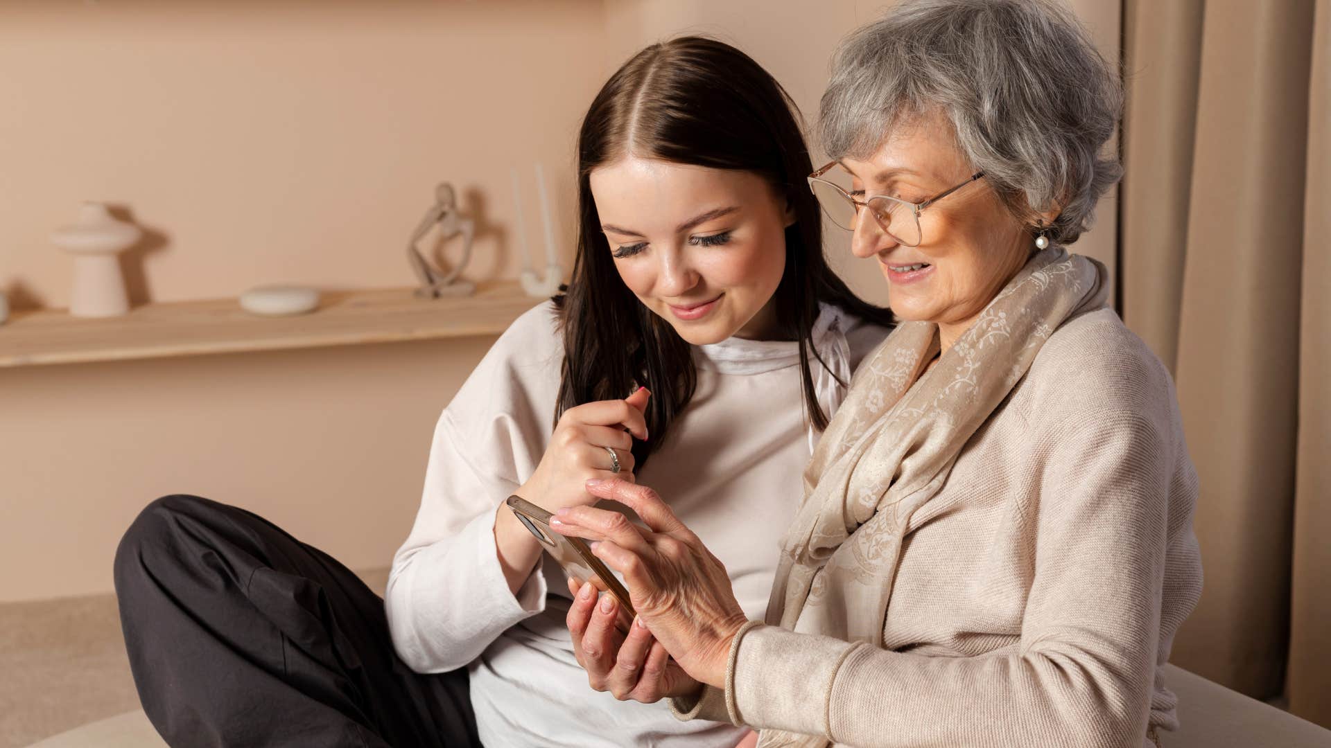 millennial woman teaching technology to her mother