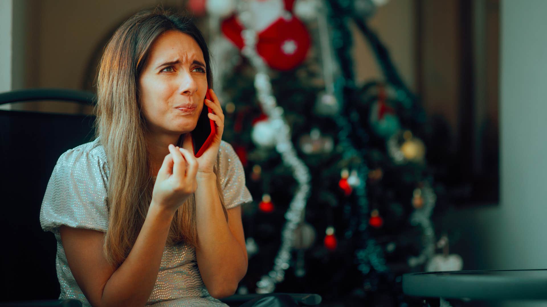 woman on the phone crying on christmas as she expects constant availability from friend